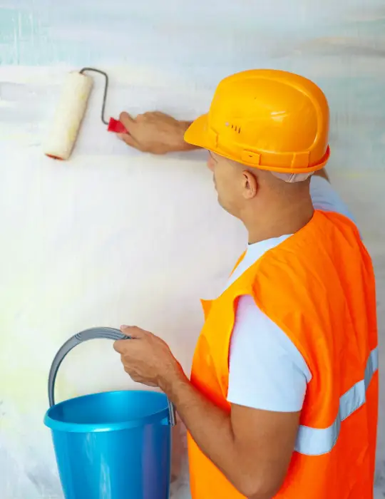 Expert House Painting Dubai, man painting wall